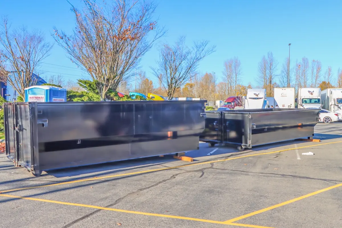 Professional dumpster rental service with roll-off container on residential driveway in Frankfort